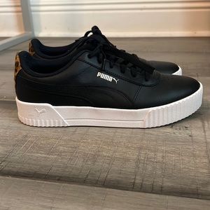 Women’s Size 9 Puma black tennis shoes with cheetah and gold accents.